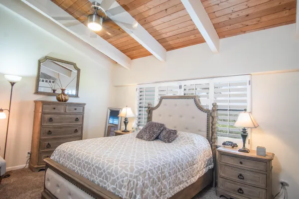 a bedroom with a bed and flat screen tv