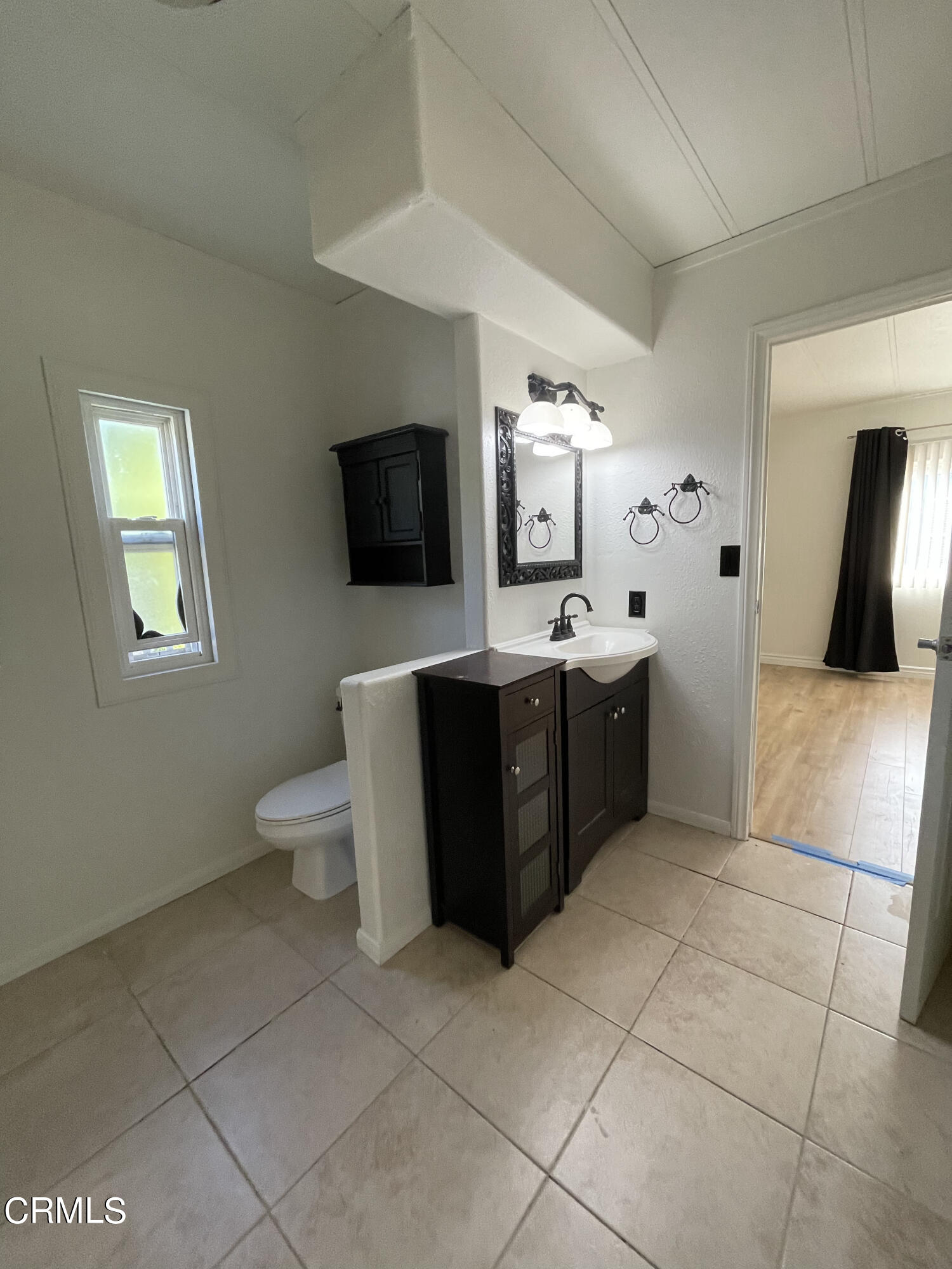 15750 Arroyo Drive, Unit 80 Moorpark, CA 93021 - Photo 11 of 19 a spacious bathroom with a toilet sink and mirror
