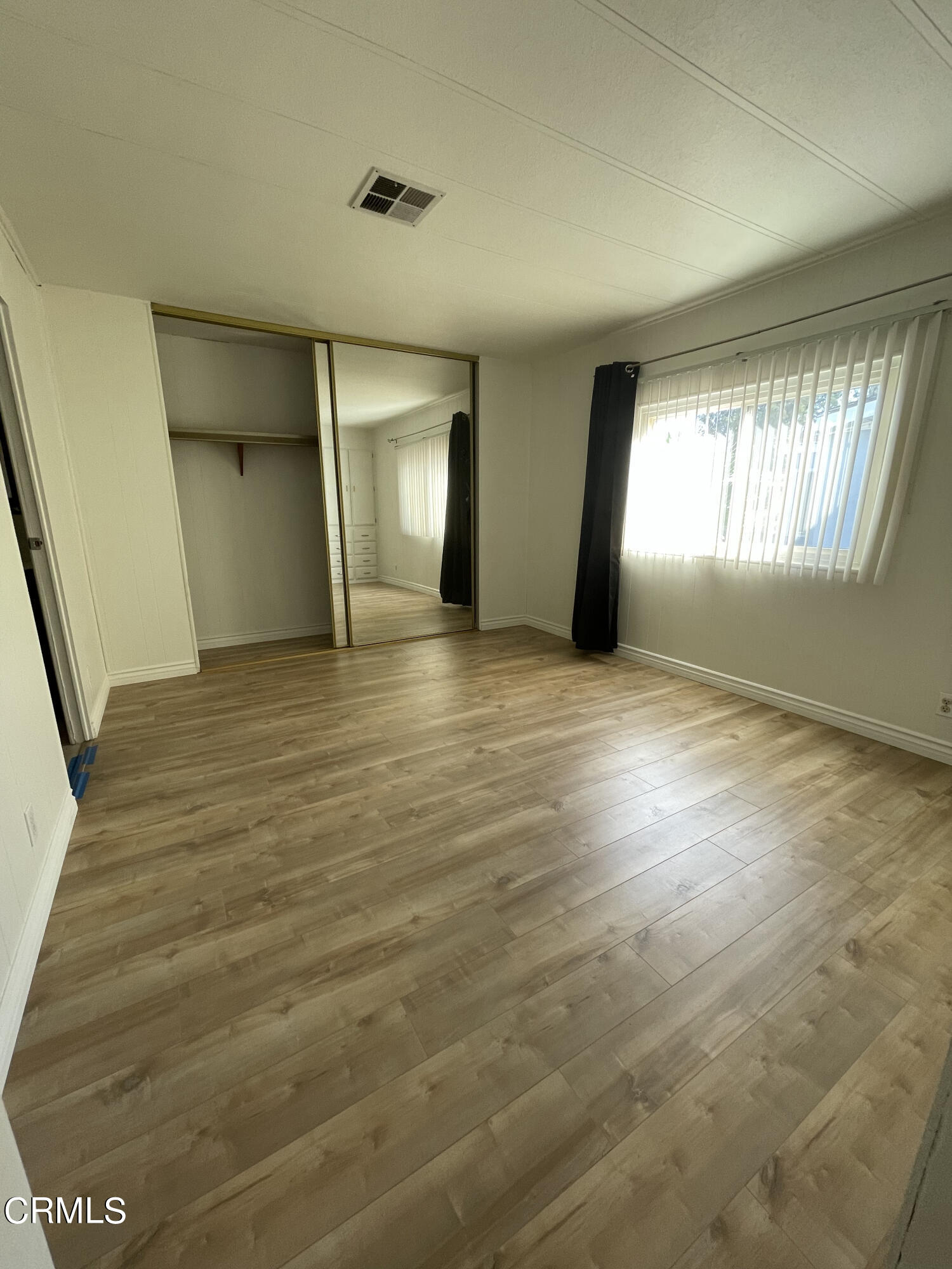 15750 Arroyo Drive, Unit 80 Moorpark, CA 93021 - Photo 10 of 19 a view of an empty room with window and wooden floor