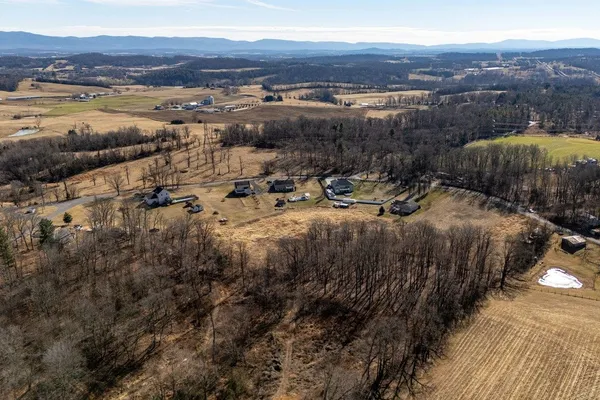 an aerial view of residential house and sandy dunes