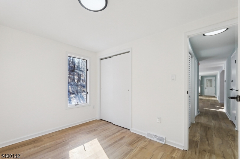 6 Maple Drive Vernon, NJ 07461 - Photo 14 of 47 a view of an empty room with wooden floor and a window
