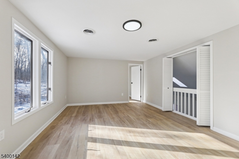 6 Maple Drive Vernon, NJ 07461 - Photo 22 of 47 a view of a livingroom with wooden floor and window