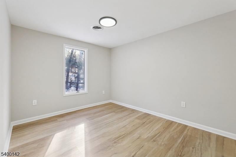 6 Maple Drive Vernon, NJ 07461 - Photo 23 of 47 wooden floor in an empty room with a window