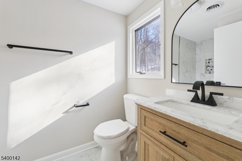6 Maple Drive Vernon, NJ 07461 - Photo 24 of 47 a bathroom with a granite countertop sink mirror vanity and toilet
