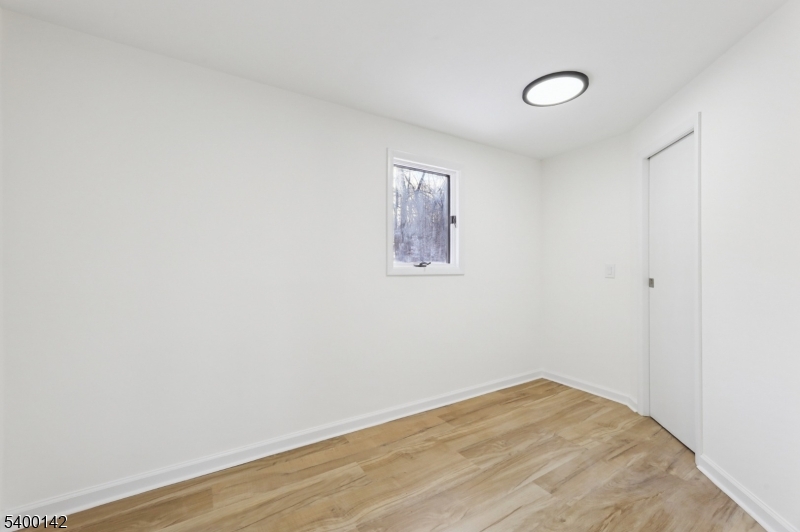 6 Maple Drive Vernon, NJ 07461 - Photo 29 of 47 a view of empty room with wooden floor