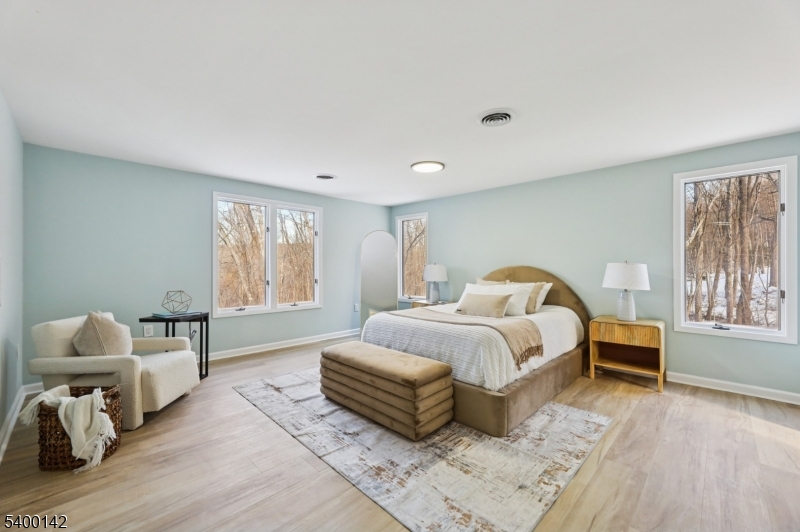 6 Maple Drive Vernon, NJ 07461 - Photo 31 of 47 a spacious bedroom with a bed and wooden floor