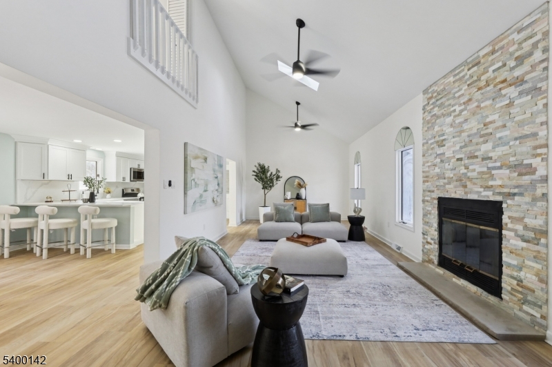 6 Maple Drive Vernon, NJ 07461 - Photo 6 of 47 a living room with furniture a fireplace and a dining table with wooden floor