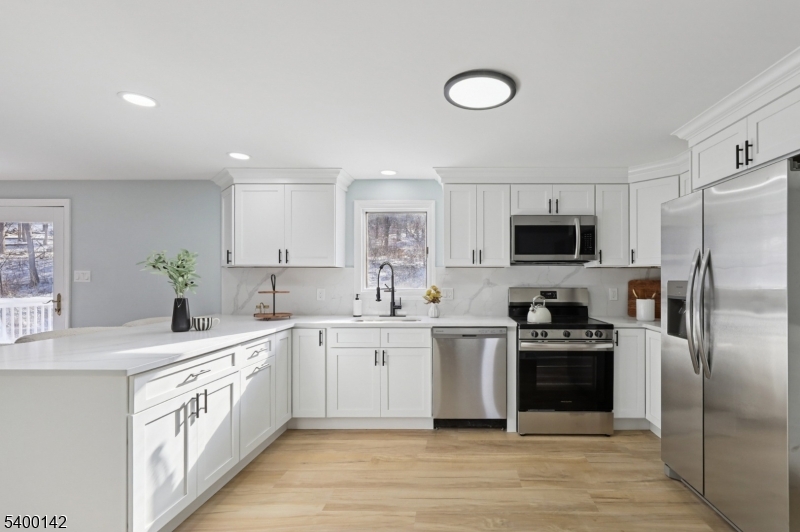 6 Maple Drive Vernon, NJ 07461 - Photo 10 of 47 a kitchen with a sink stove cabinets and refrigerator