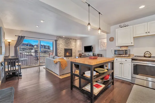 a open kitchen with stainless steel appliances granite countertop a stove and a refrigerator