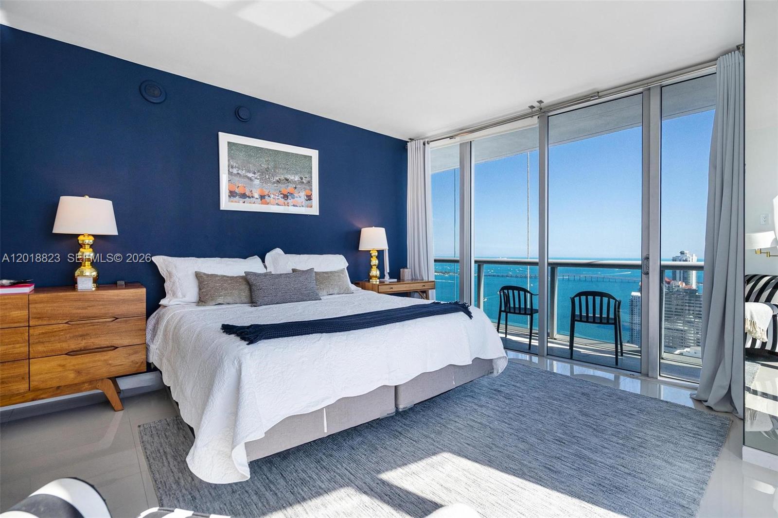 495 Brickell Avenue, Unit 4911 Miami, FL 33131 - Photo 20 of 35 a spacious bedroom with a bed and a table