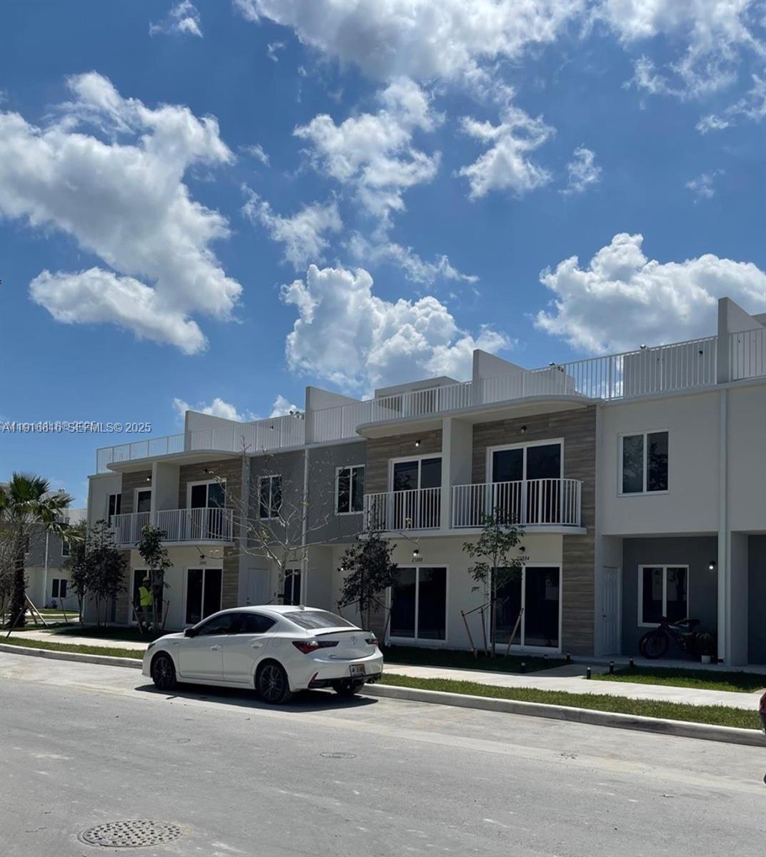 25842 Southwest 144th Avenue, Unit 25842 Homestead, FL 33032 - Photo 2 of 16 a car parked in front of a building