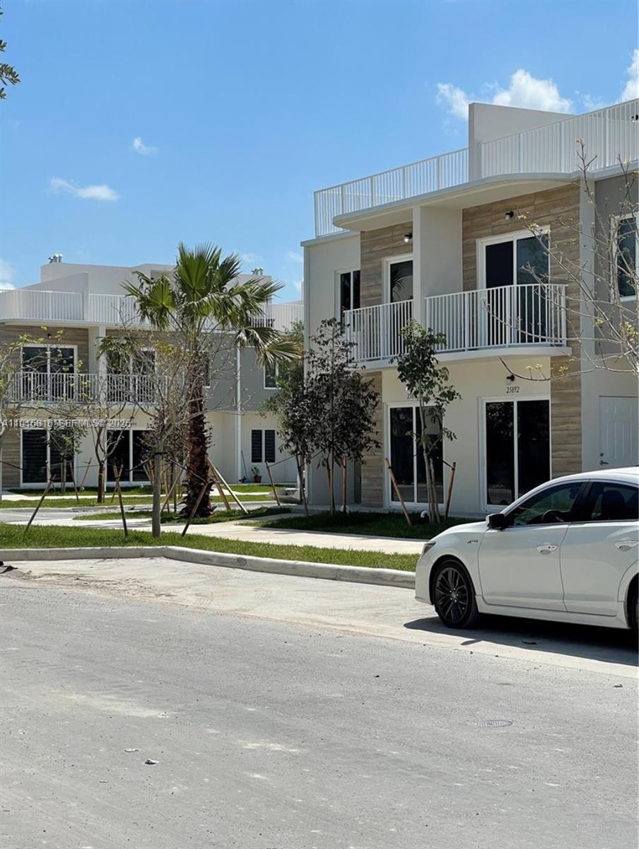 25842 Southwest 144th Avenue, Unit 25842 Homestead, FL 33032 - Photo 3 of 16 a view of a car parked in front of a house