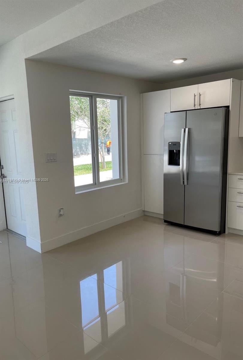 25842 Southwest 144th Avenue, Unit 25842 Homestead, FL 33032 - Photo 5 of 16 an empty room with windows