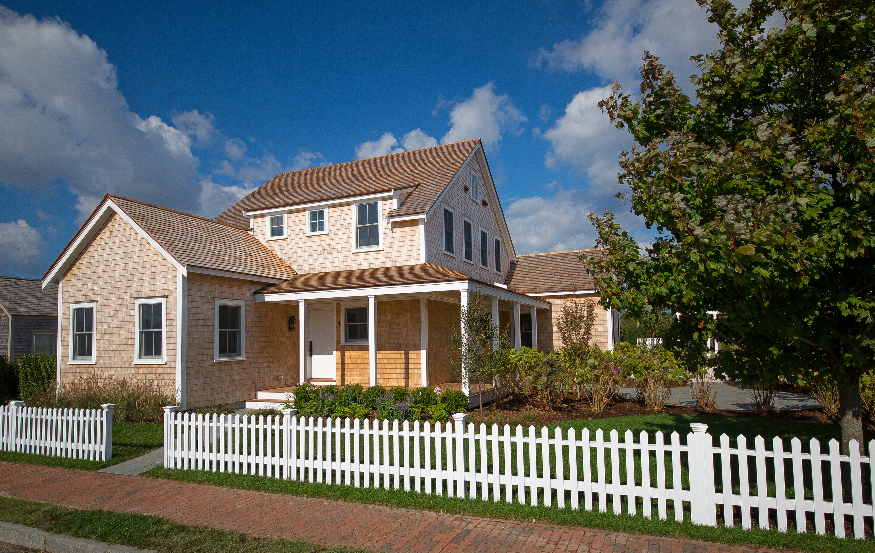 a front view of a house with a garden