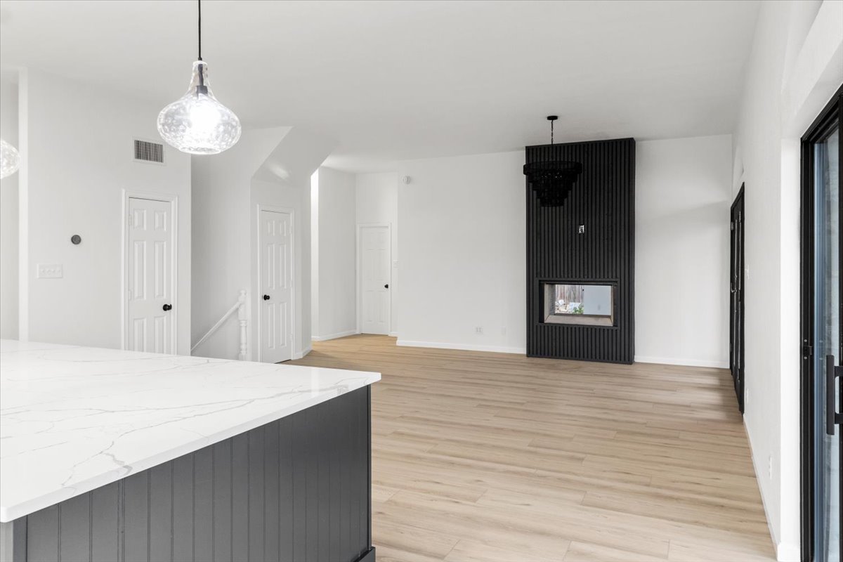 13816 Lakeview Drive Austin, TX 78732 - Photo 11 of 36 The living room is a cozy yet sophisticated space, showcasing a double-sided fireplace.