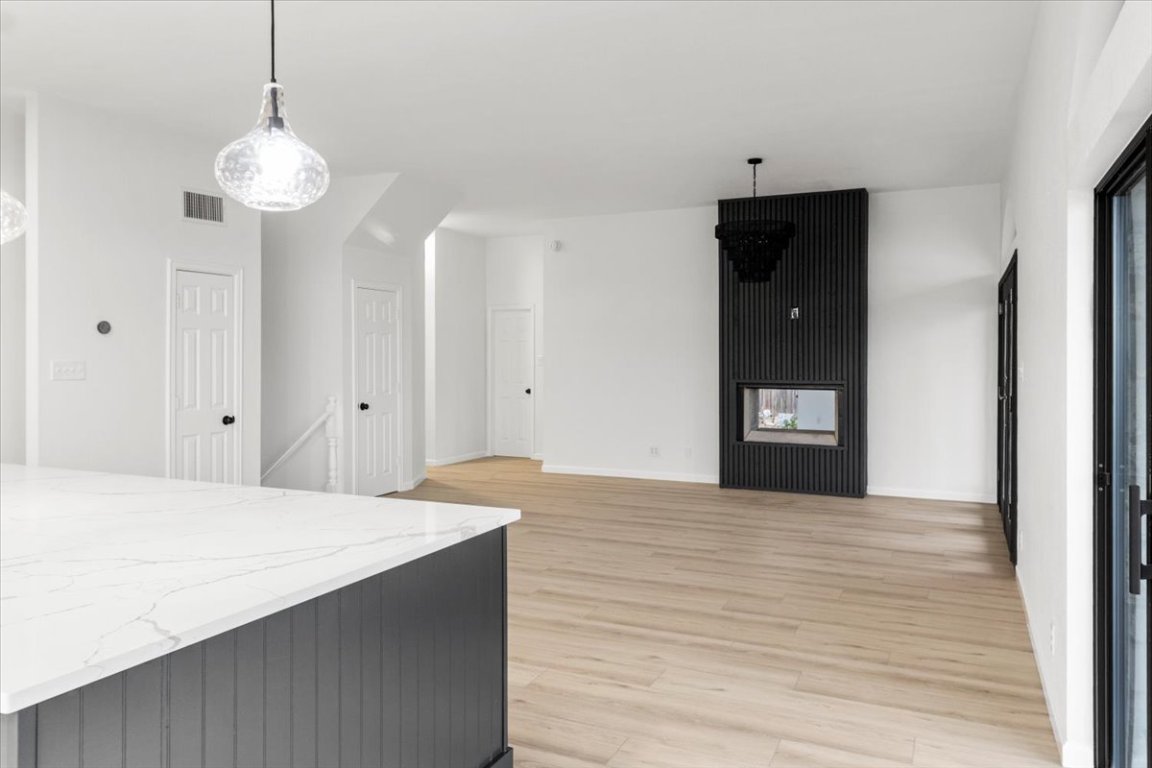 13816 Lakeview Drive Austin, TX 78732 - Photo 11 of 36 The living room is a cozy yet sophisticated space, showcasing a double-sided fireplace.