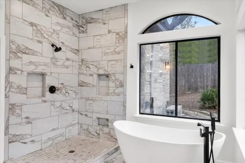 a bathroom with a bathtub and a shower
