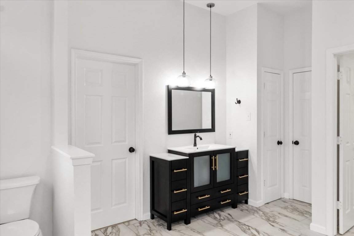 13816 Lakeview Drive Austin, TX 78732 - Photo 17 of 36 The updated vanity anchors the bright space.