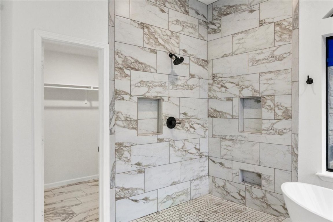 13816 Lakeview Drive Austin, TX 78732 - Photo 18 of 36 The oversized walk-in shower showcases a beautiful tile design with multiple niches.
