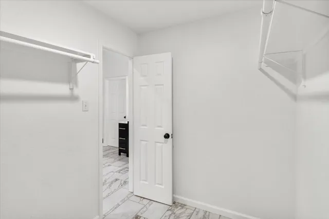 a bedroom with a large bed and a large window