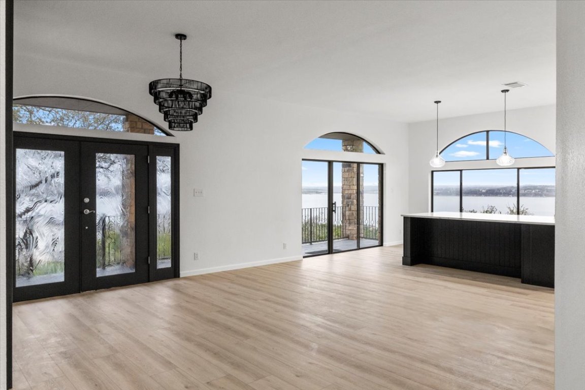 13816 Lakeview Drive Austin, TX 78732 - Photo 2 of 36 Stepping inside, the home is wrapped in windows and doors that frame captivating views.