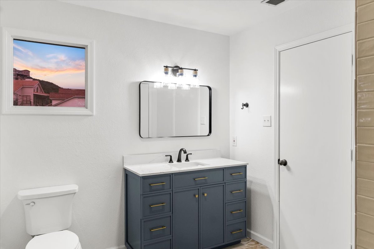 13816 Lakeview Drive Austin, TX 78732 - Photo 31 of 36 While remaining neutral, the vanity adds a touch of color to the space.