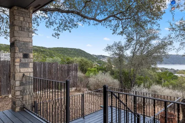 a large kitchen with stainless steel appliances a large counter top a cabinetry and a wooden floor