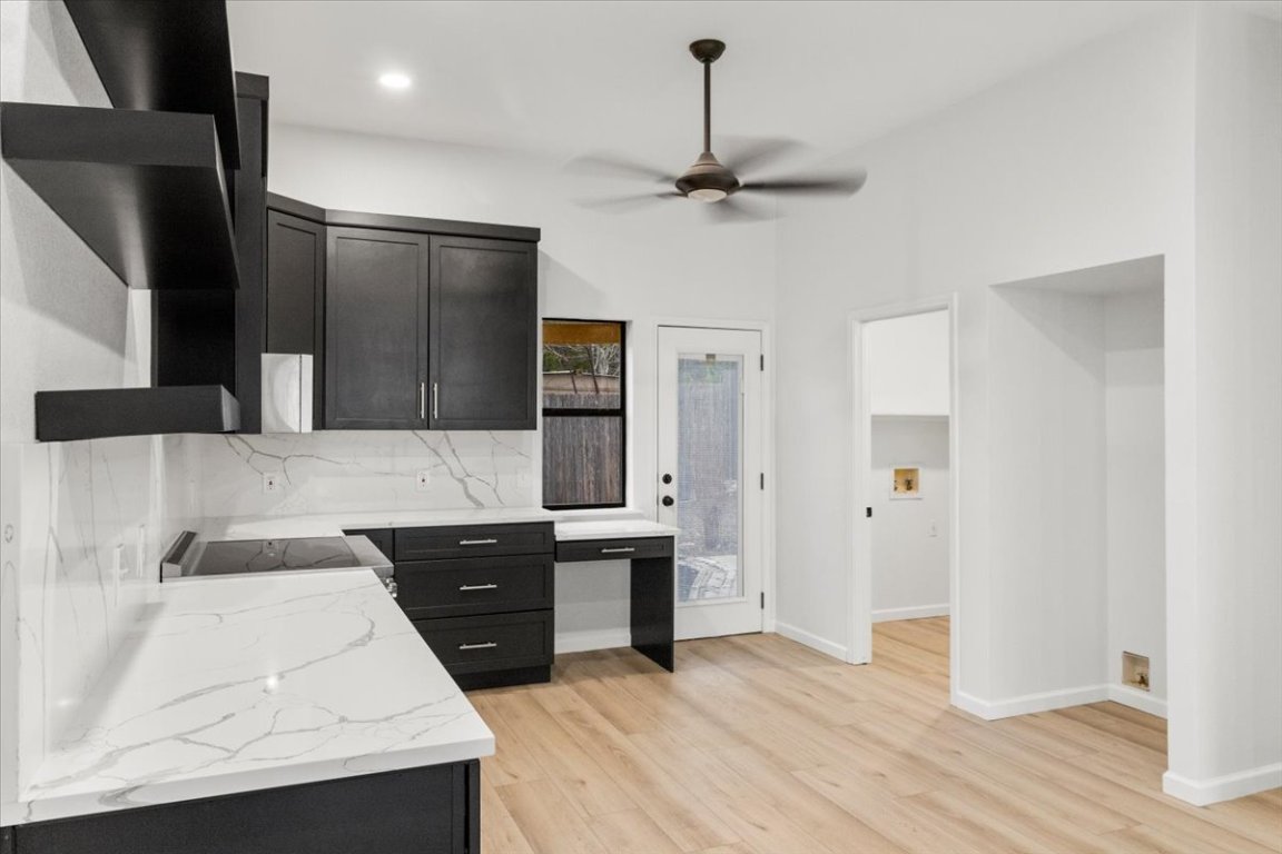 13816 Lakeview Drive Austin, TX 78732 - Photo 10 of 36 Sleek quartz counters in the kitchen flow into the backsplash.