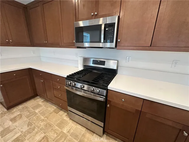 a kitchen with a cabinets and a refrigerator
