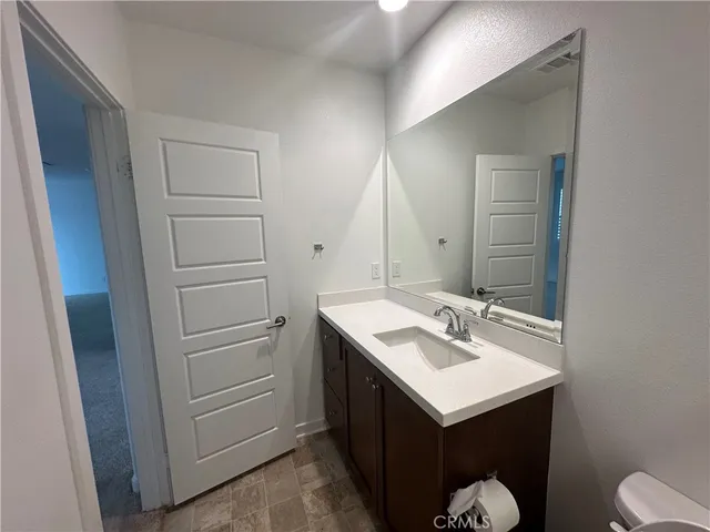 a spacious bathroom with a double vanity sink and mirror with shower