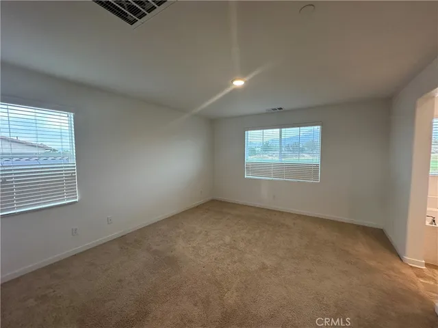 a bathroom with a granite countertop toilet and a sink