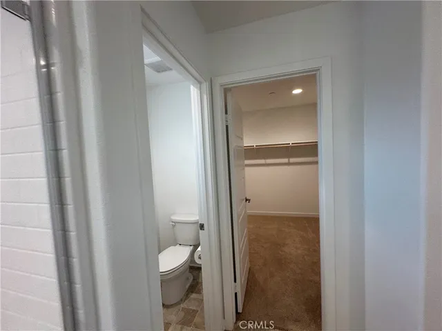 a bathroom with a double vanity sink toilet mirror and shower