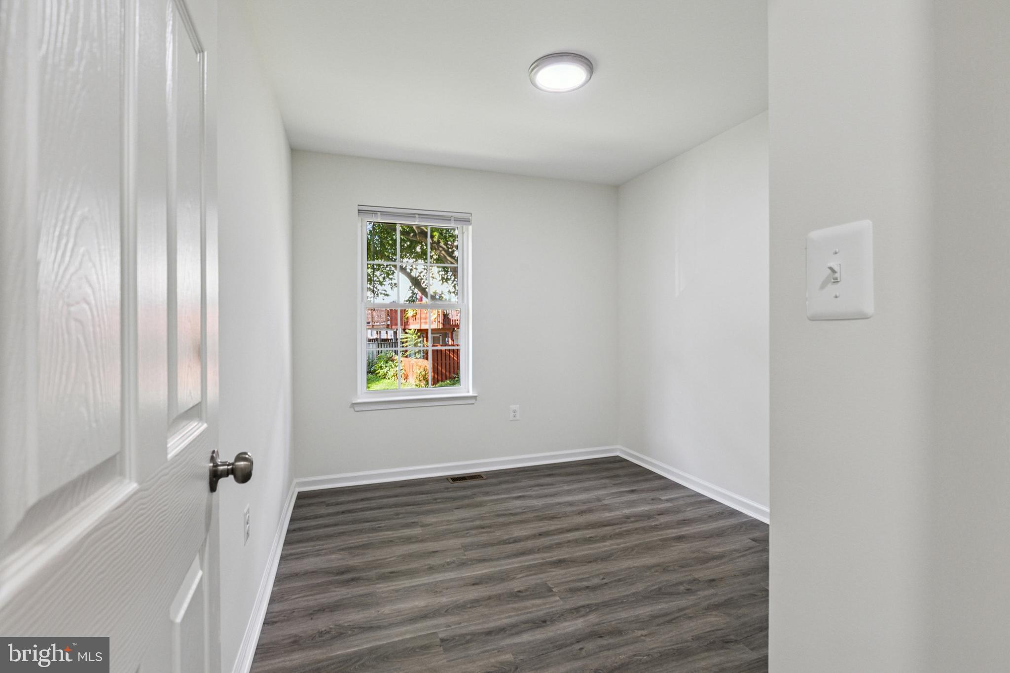 20209 Thunderhead Way Germantown, MD 20874 - Photo 12 of 26 wooden floor in an empty room with a window