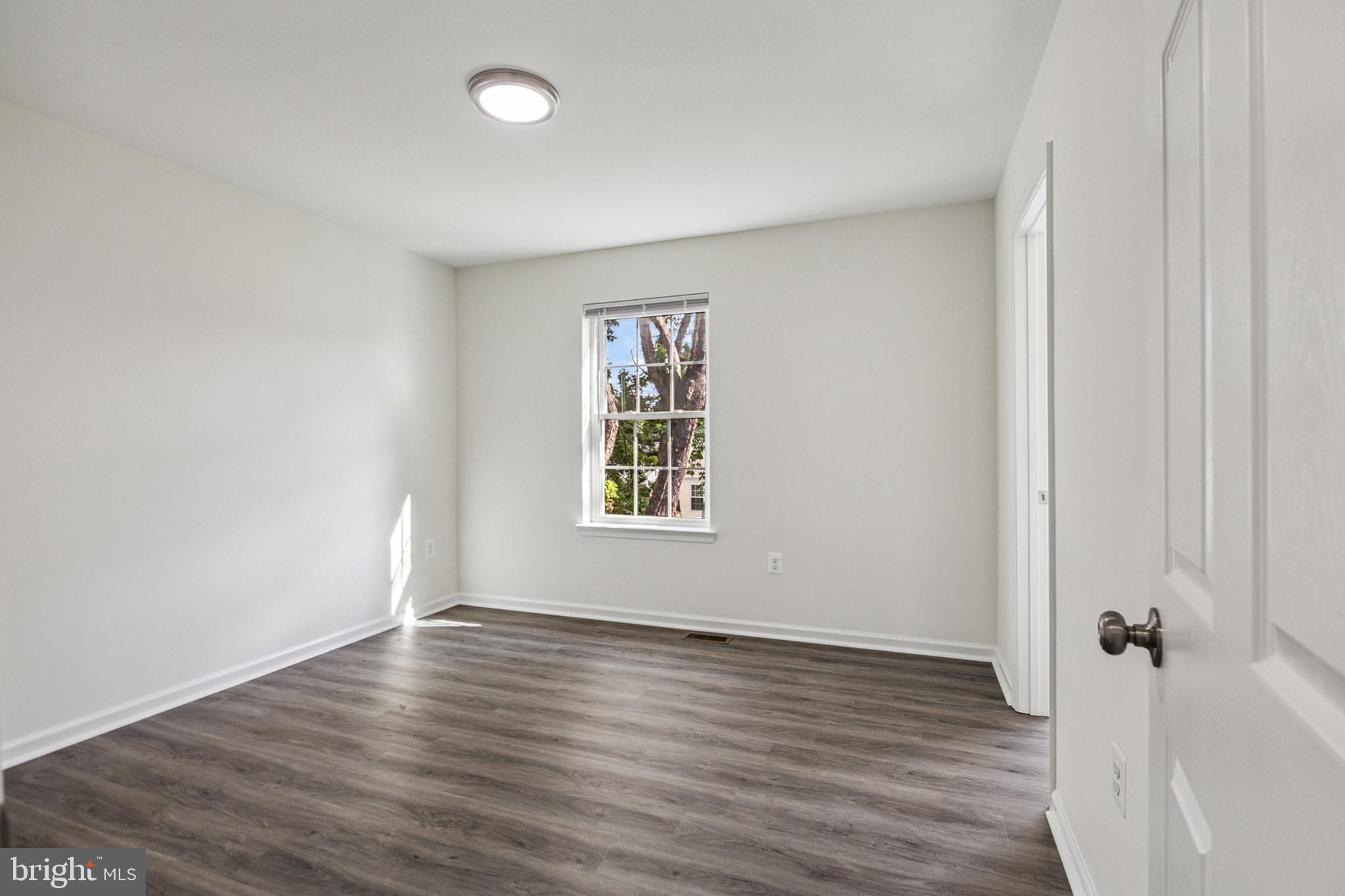 20209 Thunderhead Way Germantown, MD 20874 - Photo 14 of 26 an empty room with wooden floor and windows