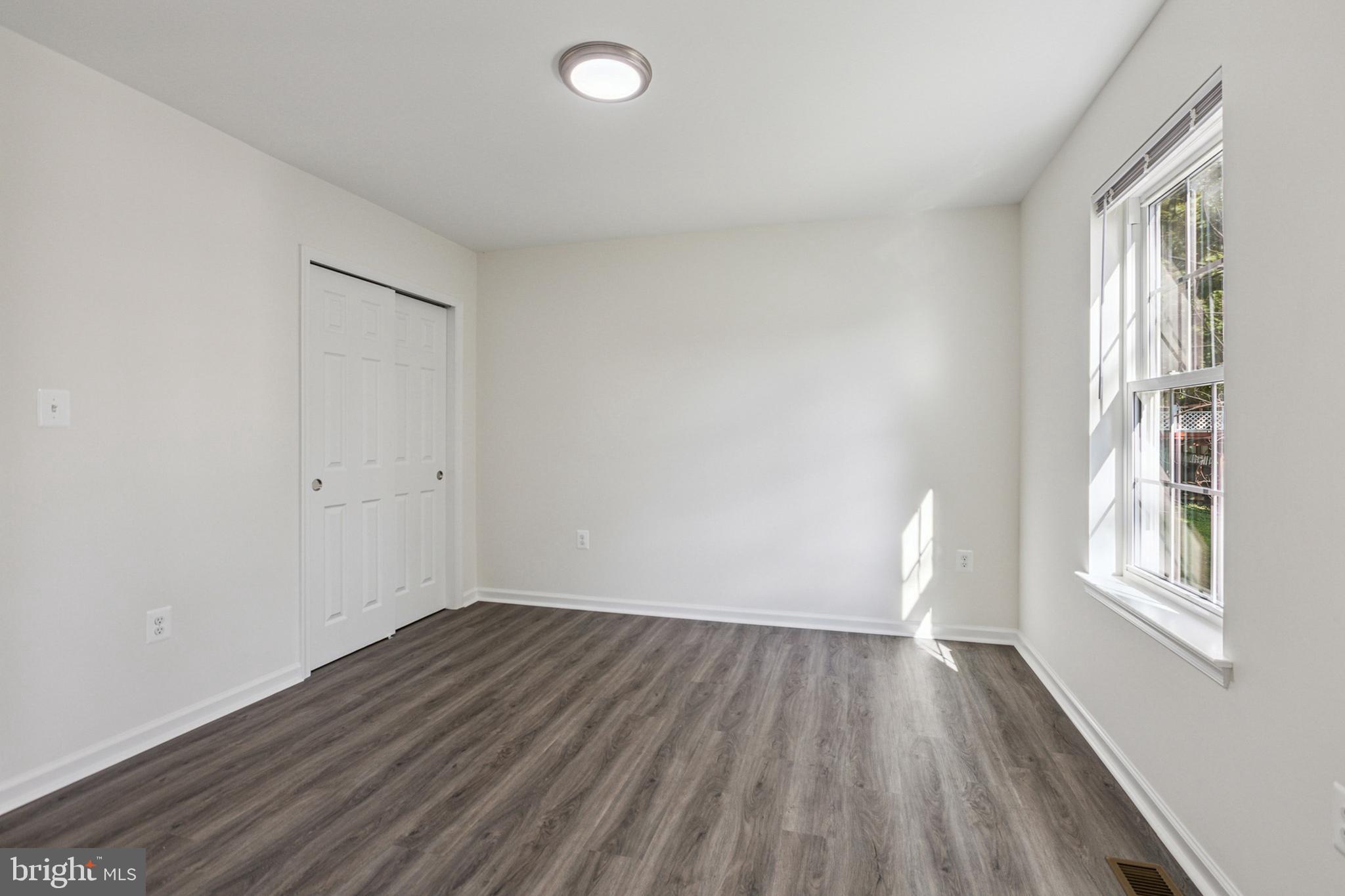 20209 Thunderhead Way Germantown, MD 20874 - Photo 16 of 26 an empty room with wooden floor and windows