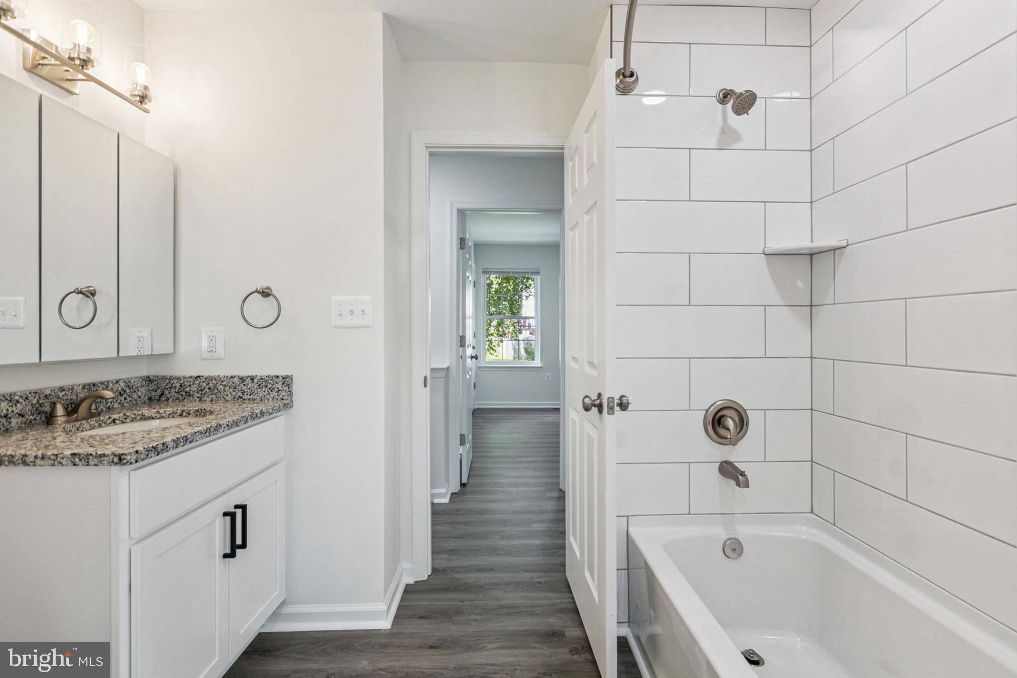 20209 Thunderhead Way Germantown, MD 20874 - Photo 18 of 26 a bathroom with a granite countertop sink a toilet and shower