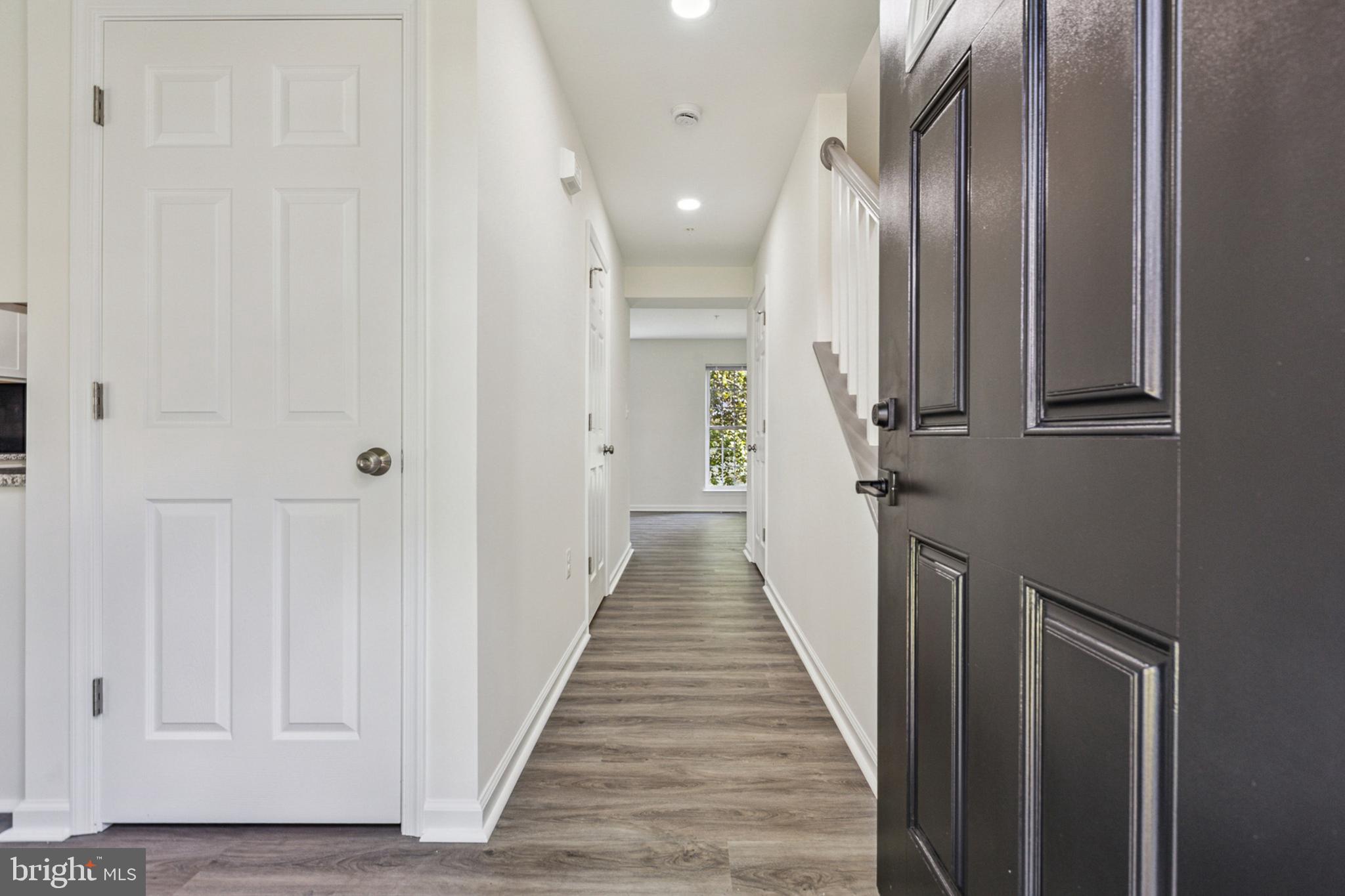 20209 Thunderhead Way Germantown, MD 20874 - Photo 2 of 26 a view of a hallway with wooden floor and staircase