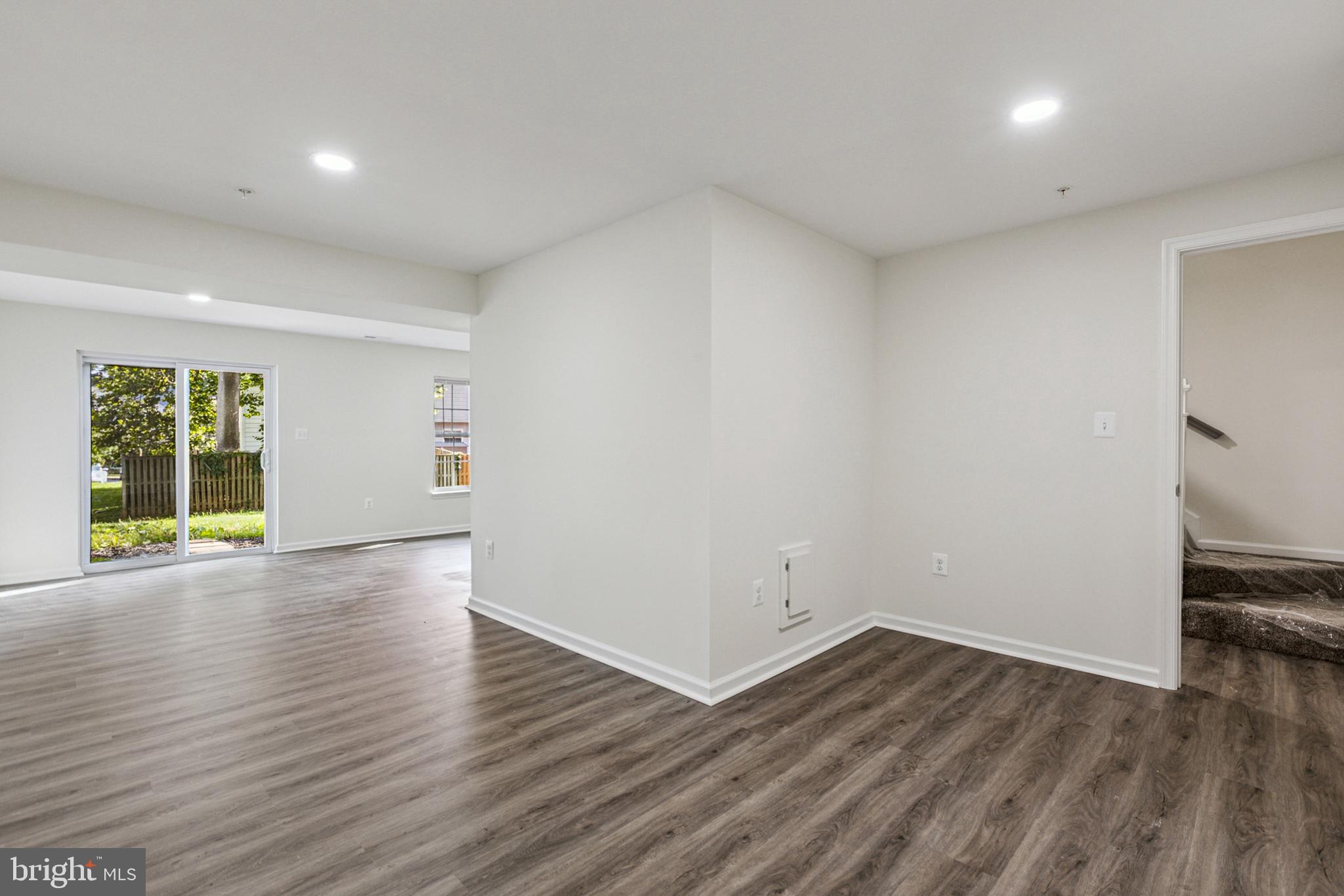 20209 Thunderhead Way Germantown, MD 20874 - Photo 22 of 26 a view of an empty room with wooden floor and windows