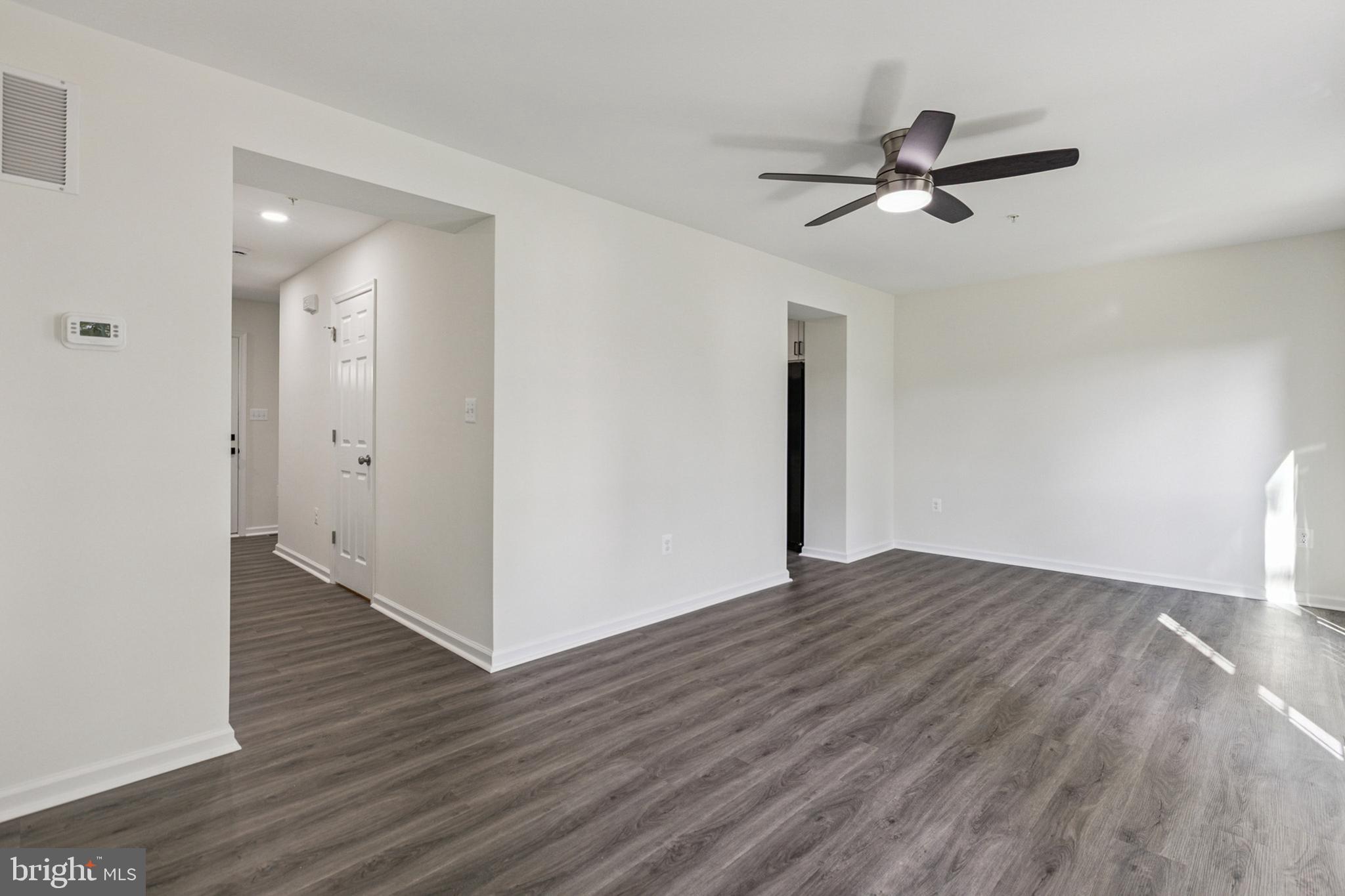 20209 Thunderhead Way Germantown, MD 20874 - Photo 3 of 26 a view of a livingroom with wooden floor and a ceiling fan