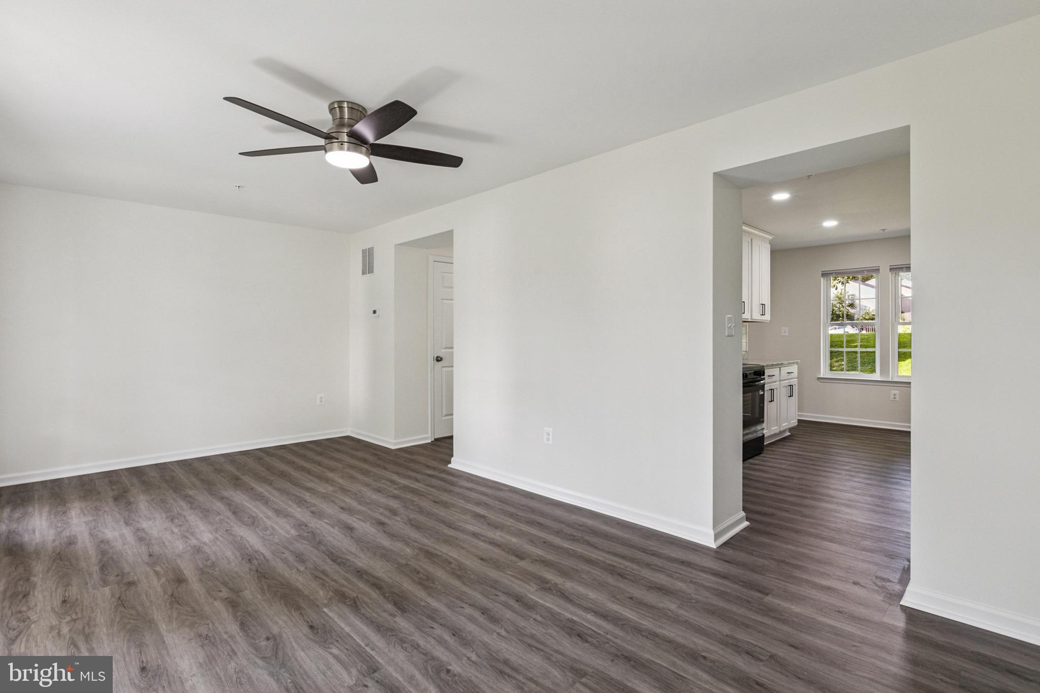 20209 Thunderhead Way Germantown, MD 20874 - Photo 4 of 26 a view of a hallway with wooden floor and a bathroom