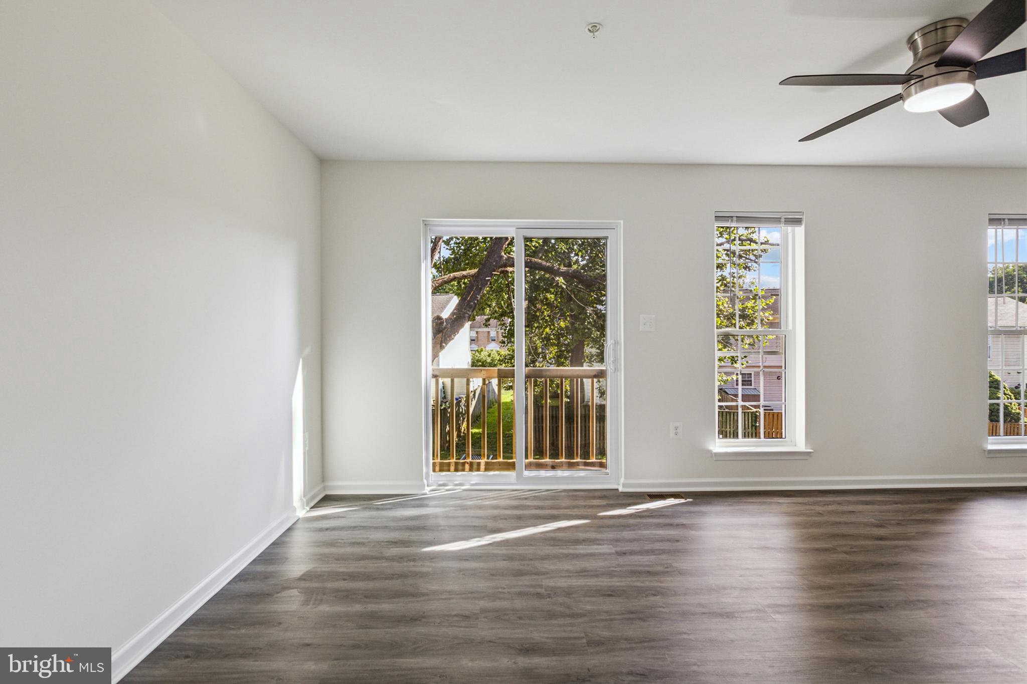 20209 Thunderhead Way Germantown, MD 20874 - Photo 5 of 26 a view of an empty room with wooden floor and a window