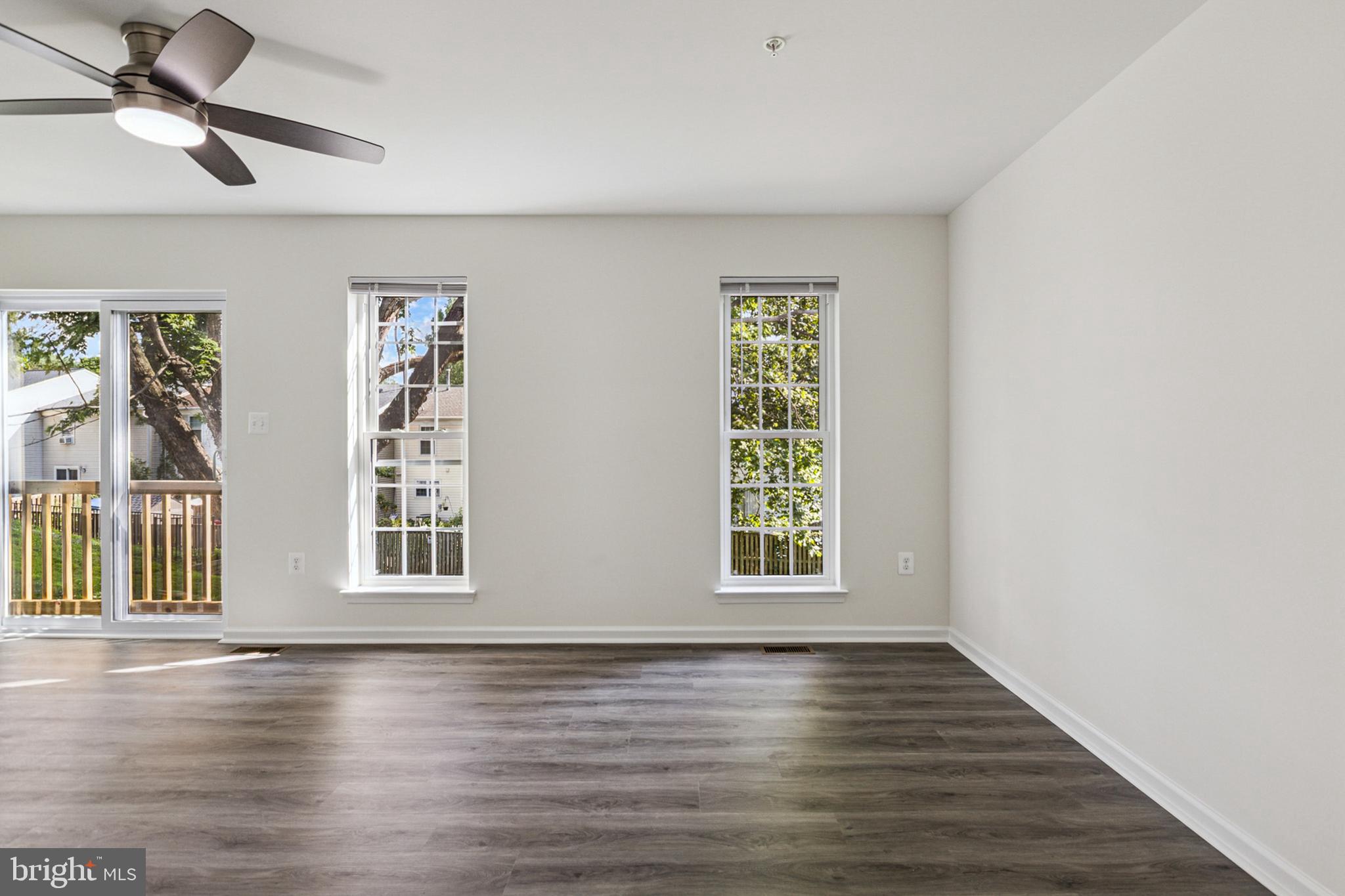 20209 Thunderhead Way Germantown, MD 20874 - Photo 6 of 26 a view of an empty room with wooden floor and a window