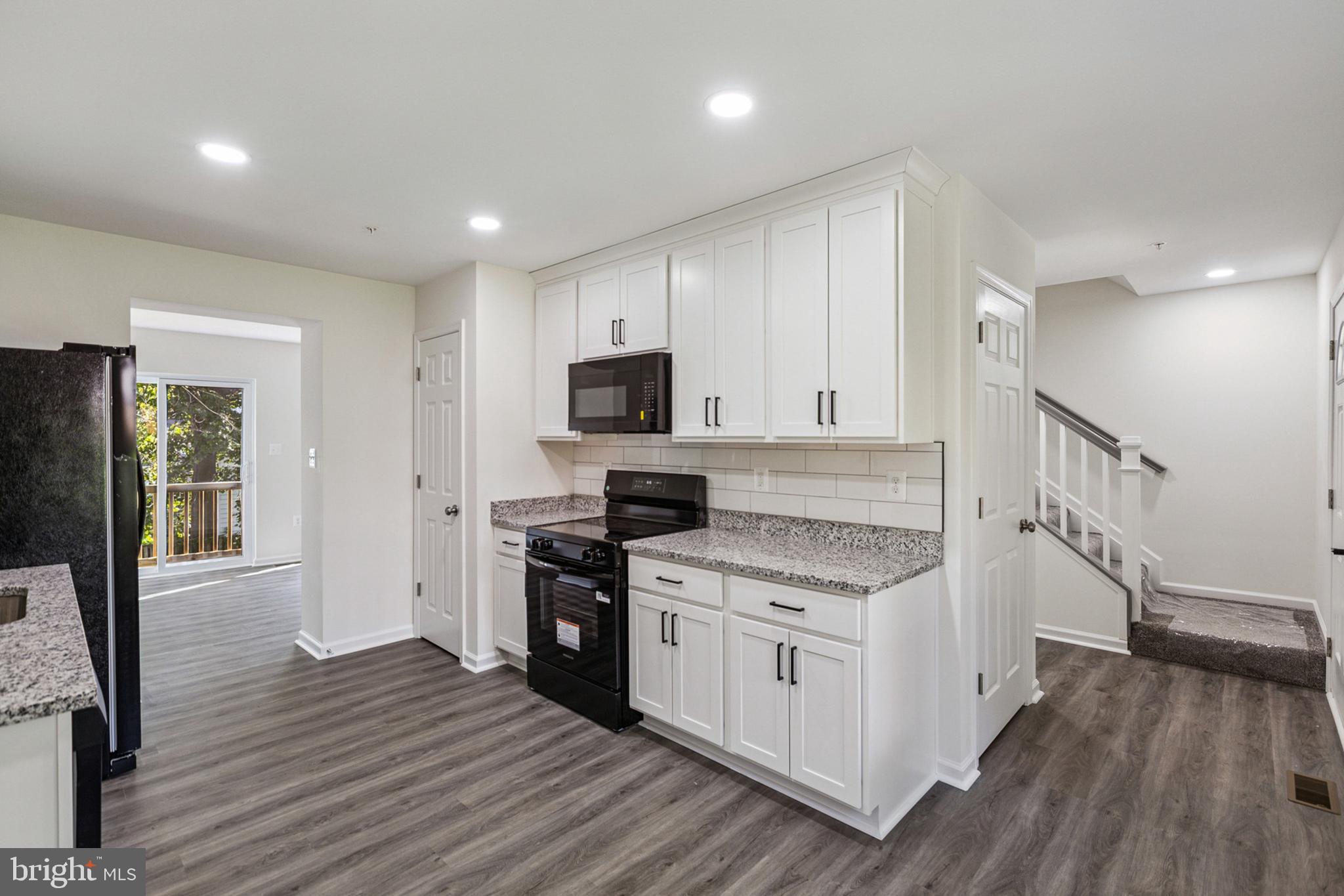 20209 Thunderhead Way Germantown, MD 20874 - Photo 7 of 26 a kitchen with a stove a sink and a refrigerator