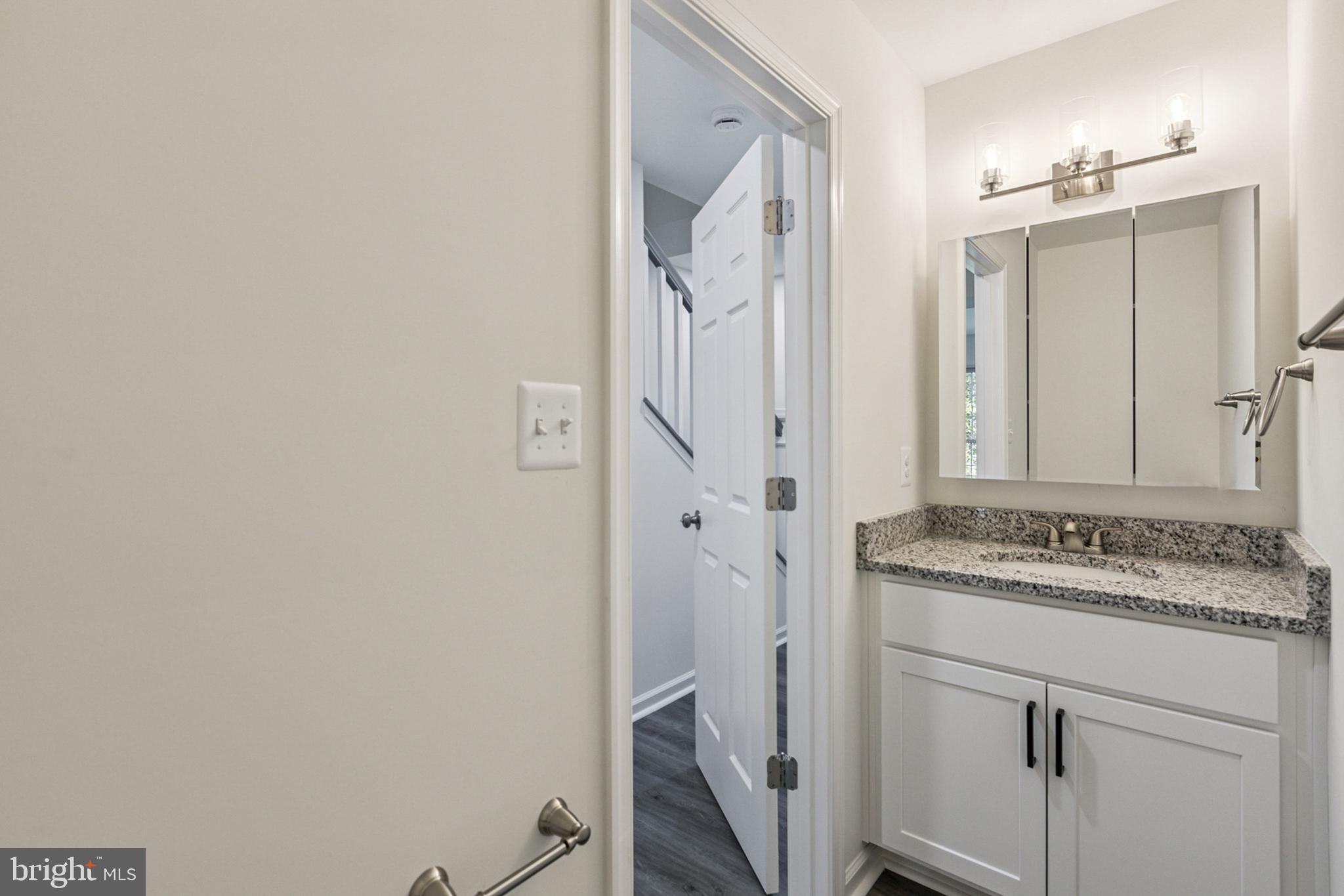 20209 Thunderhead Way Germantown, MD 20874 - Photo 9 of 26 a bathroom with a granite countertop sink and a mirror
