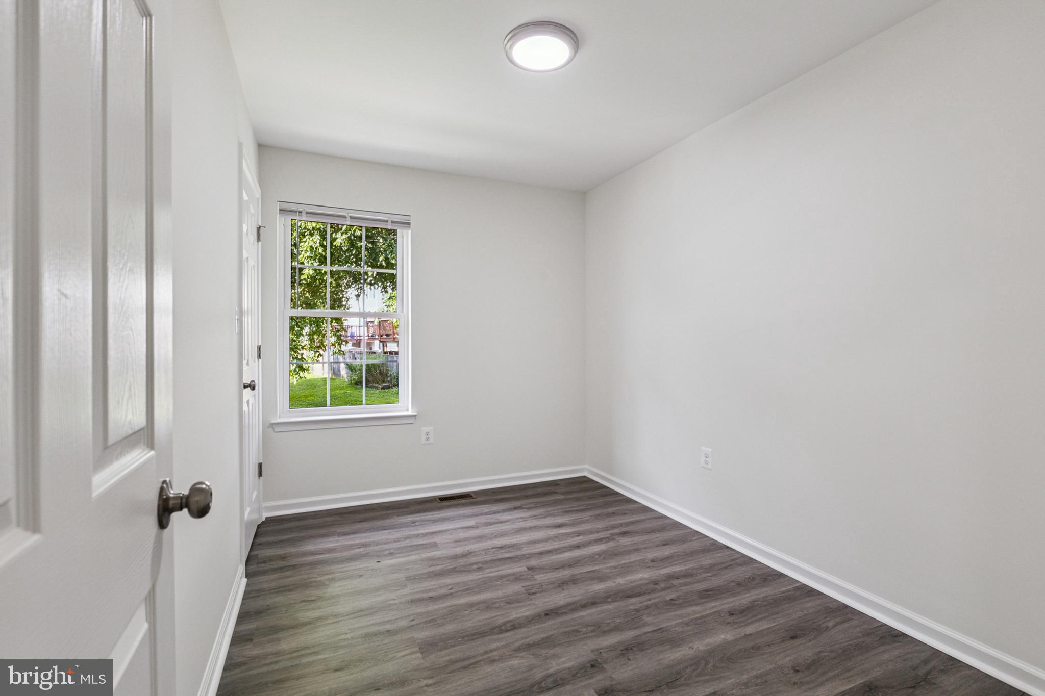 20209 Thunderhead Way Germantown, MD 20874 - Photo 10 of 26 an empty room with wooden floor and windows