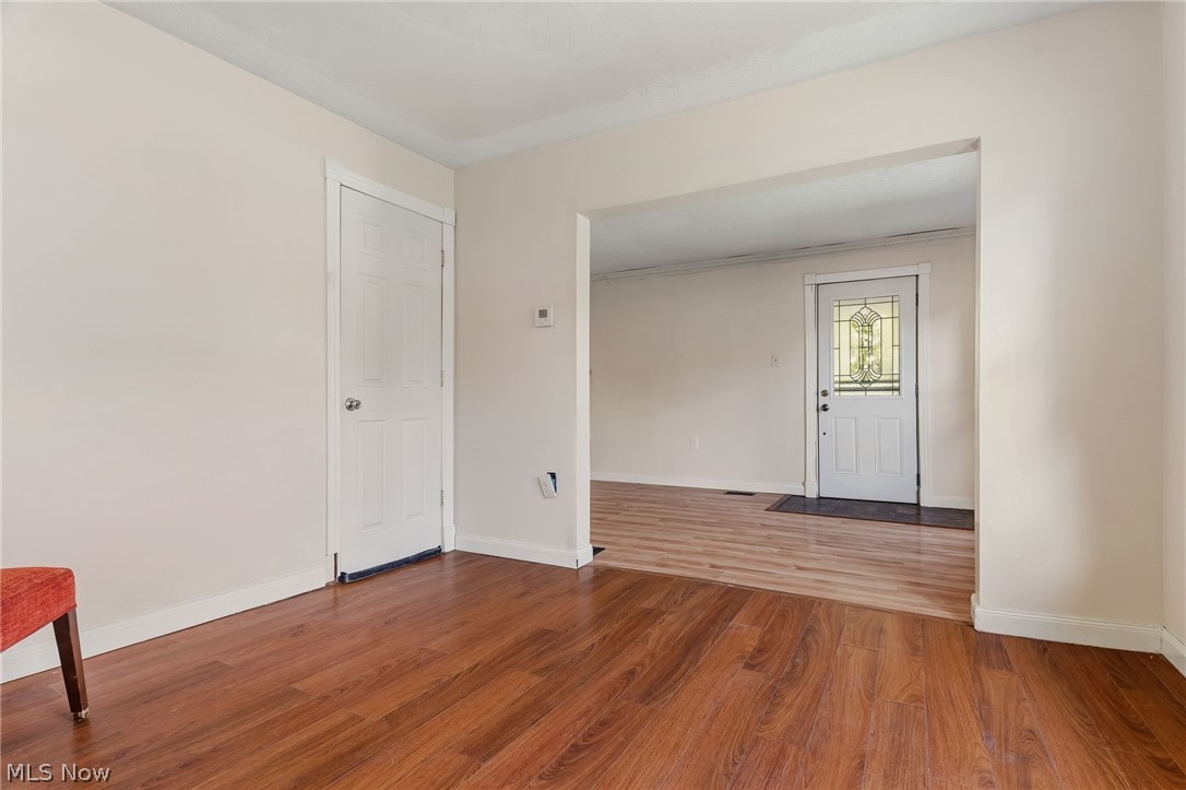 4619 Ridge Avenue Southeast Canton, OH 44707 - Photo 7 of 26 Wood-finish flooring throughout, bright white interior doors, and a decorative glass panel entry door