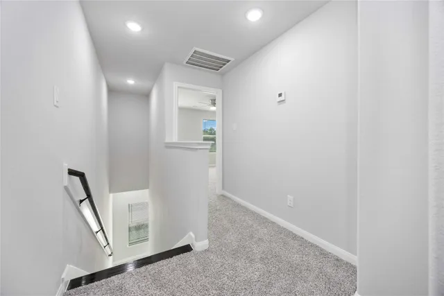 a view of a hallway with a room