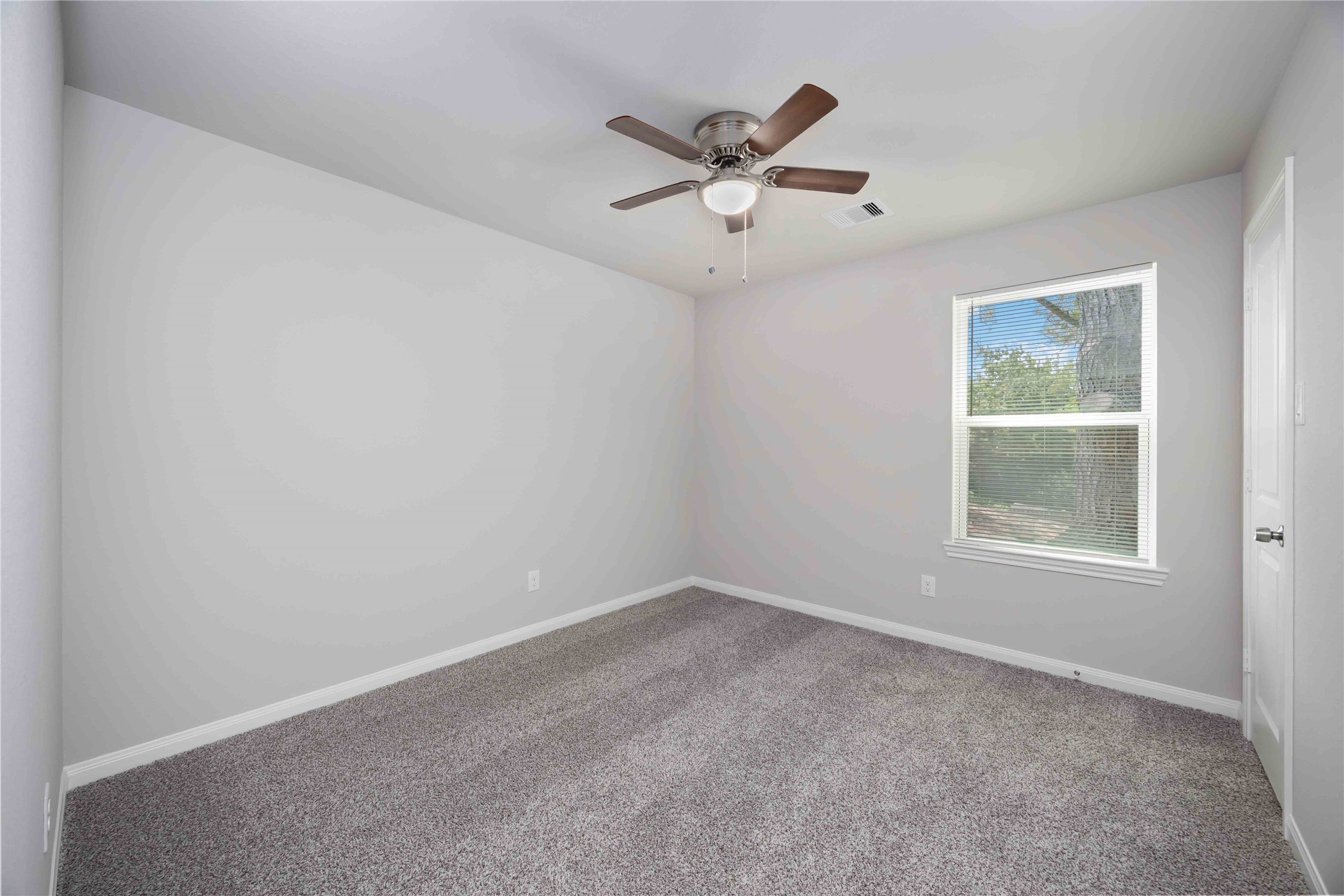 7987 Chateau Street, Unit A Houston, TX 77028 - Photo 18 of 24 an empty room with a window and a fan