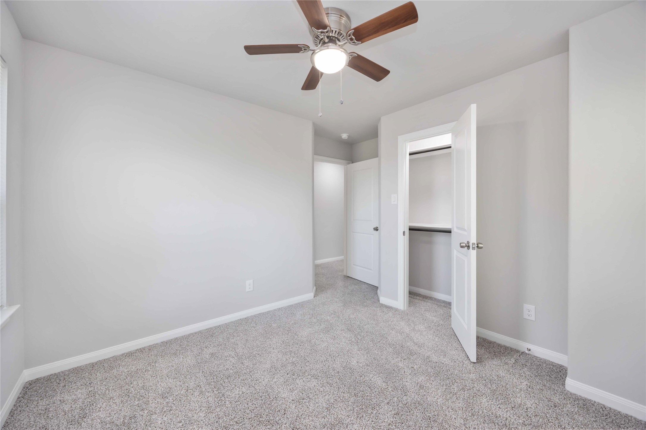7987 Chateau Street, Unit A Houston, TX 77028 - Photo 21 of 24 an empty room with closet and a ceiling fan