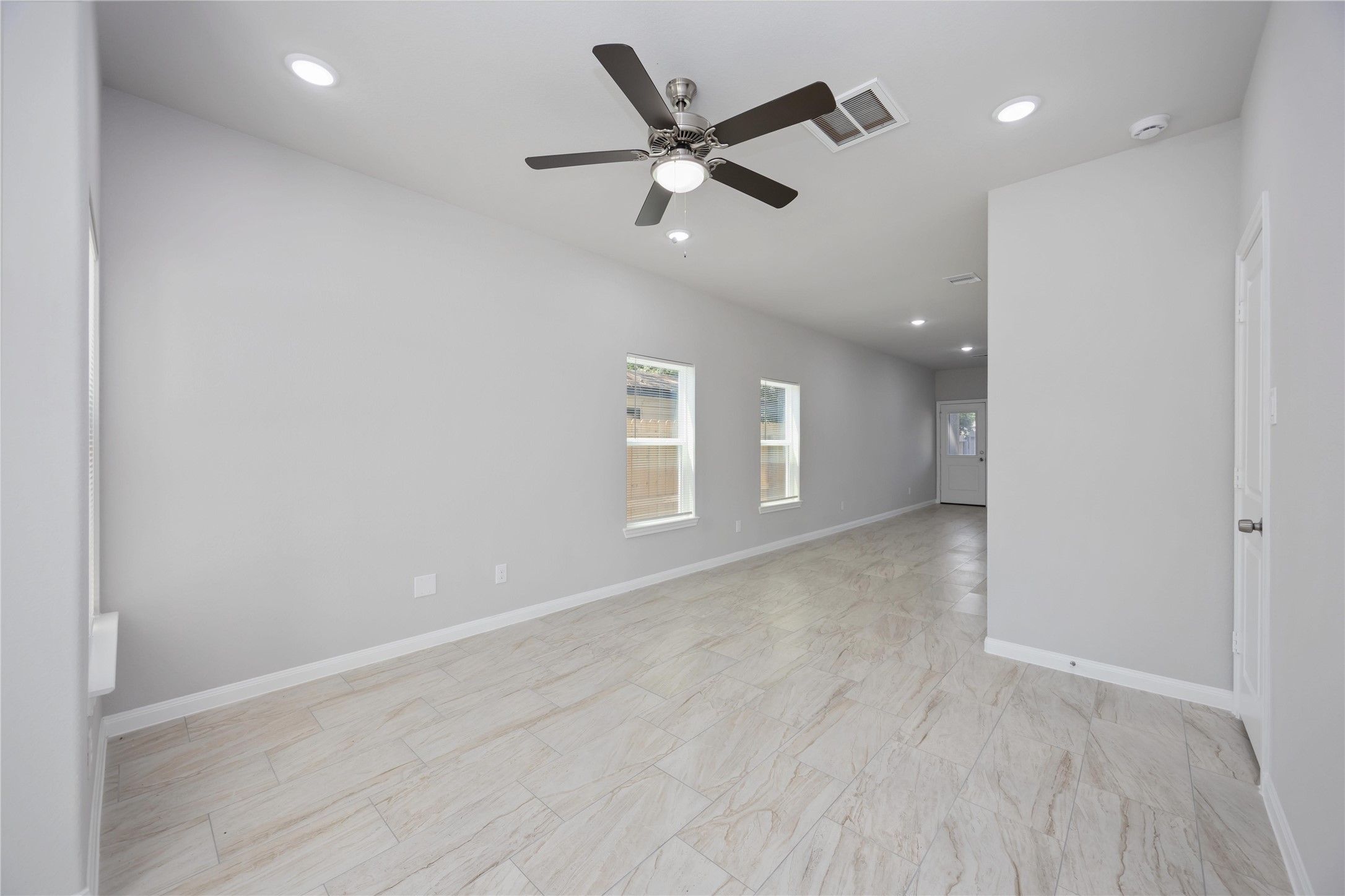 7987 Chateau Street, Unit A Houston, TX 77028 - Photo 5 of 24 an empty room with wooden floor and windows